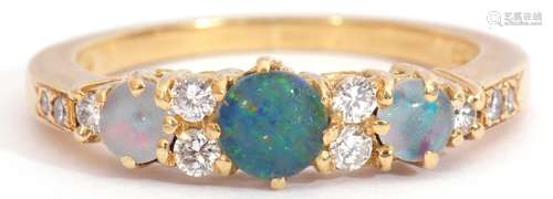 18ct gold, opal and diamond ring, featuring three graduated round cut opals, interspersed by ten