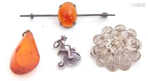 Mixed Lot: white metal penny-farthing charm, a filigree brooch, an amber drop pendant and a