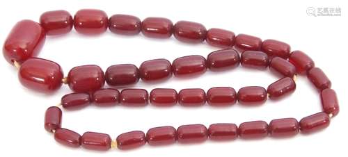 Vintage cherry red amber bead necklace, a single row of graduated oblong beads, 1cm - 2.5cm diam,