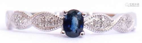 Modern sapphire and diamond ring centring an oval faceted sapphire, raised above diamond set plaited