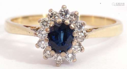 18ct gold sapphire and diamond cluster ring, the oval faceted sapphire multi-claw set above a