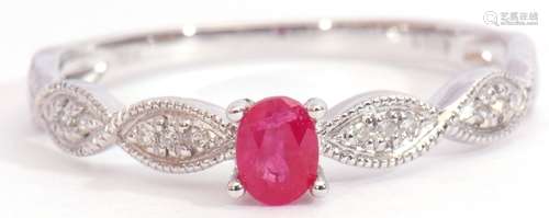 Modern ruby and diamond set ring centring an oval faceted ruby, raised between small diamond set