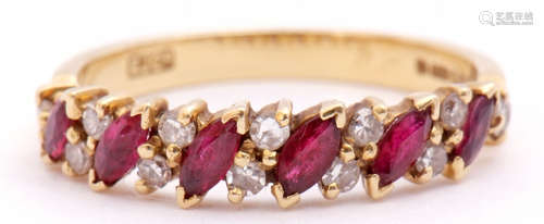 An 18ct gold, ruby and diamond ring, alternate set with angled lozenge shaped rubies and pairs of