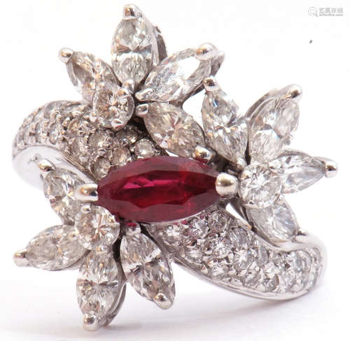 Precious metal, ruby and diamond cluster cocktail ring, centring a marquis shaped ruby raised