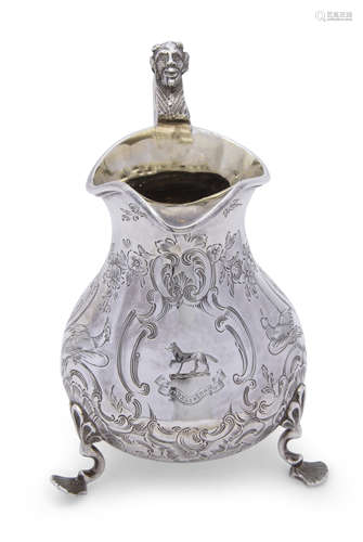 Victorian milk jug of pear shape with gilded interior, mask and dolphin head curved handle, the body