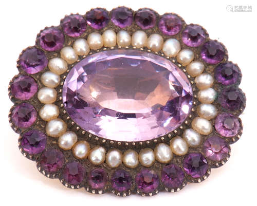 Victorian amethyst and seed pearl brooch, the large oval faceted amethyst 17mm x 12mm, within a seed