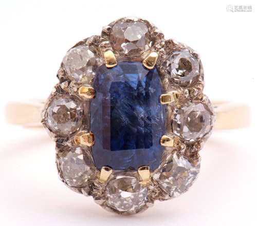 Sapphire and diamond cluster ring, the centre rectangular step cut sapphire 8 x 6mm, surrounded by 8