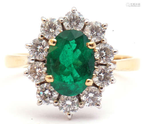 Emerald and diamond cluster ring, the oval faceted cut emerald 1.14ct approx, set within a