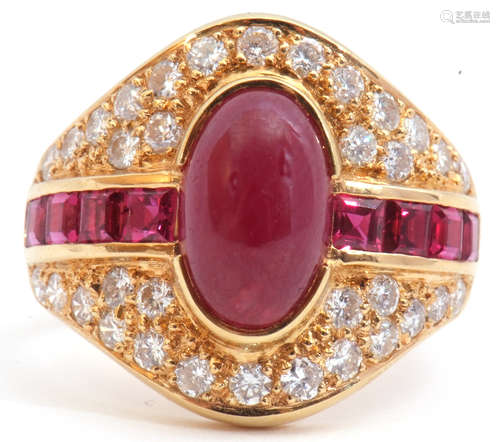 18ct gold ruby and diamond cluster ring, the oval shaped panel centring a cabochon ruby, flanked