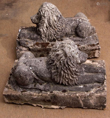 Pair of weathered composition models of reclining lions standing on integral bases (some losses