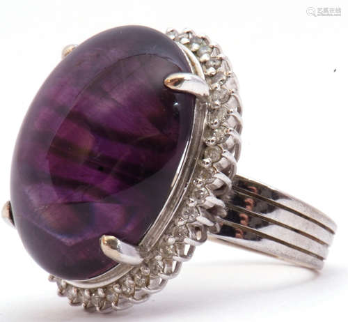 Large amethyst and diamond dress ring, the large oval shaped cabochon 24mm x 24mm, four claw set and