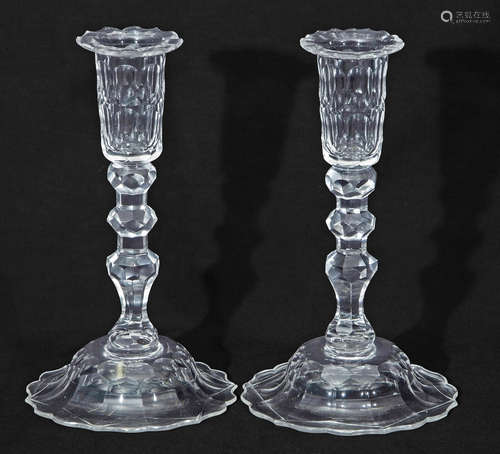 Pair of glass candlesticks, 19th century, with knopped faceted stems on a domed base, 23cm high