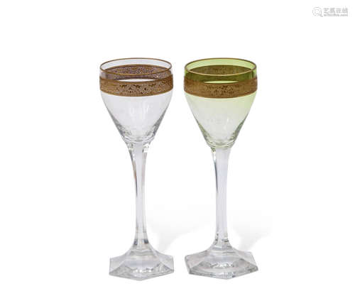 Pair of wine glasses, probably Moser, with green tint and a gilt engraved band above a faceted