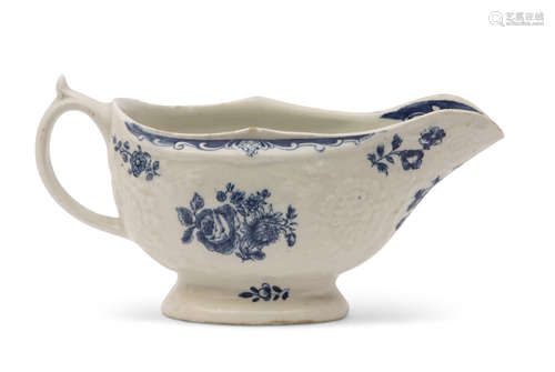 Lowestoft porcelain sauce boat decorated in blue and white with floral prints