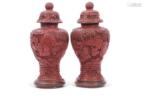 Pair of cinnabar style vases and covers, 24cm high