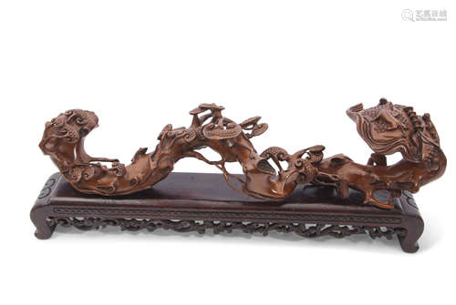 Chinese root carving on black wooden mount, 48cm long