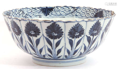 A Chinese porcelain bowl, Kangxi, the fluted body decorated with alternating flowerheads in Ming