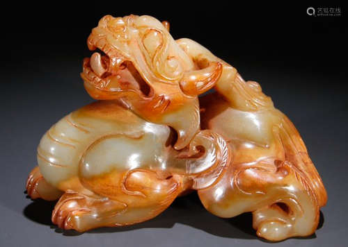 AN ANTIQUE JADE BEAST PENDANT