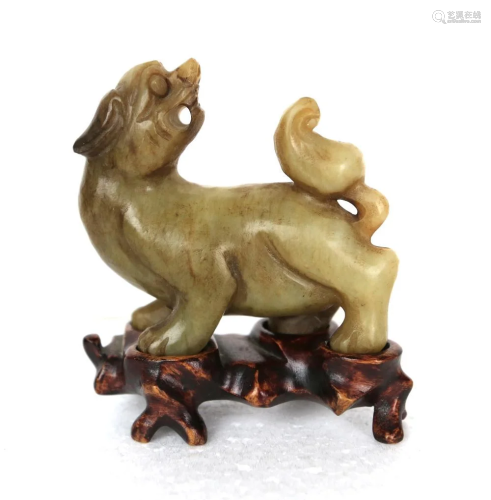 a chinese jade animal with wood stand