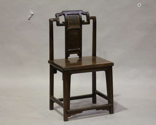 A Chinese hardwood chair, late Qing dynasty, the shaped top rail above a splat back with shou