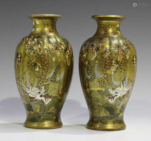 A pair of Japanese Satsuma earthenware vases, Meiji period, each ribbed ovoid body painted and