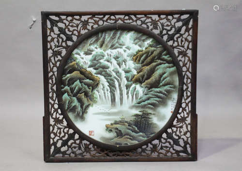 A large Chinese porcelain circular plaque, 20th century, painted with a mountainous landscape