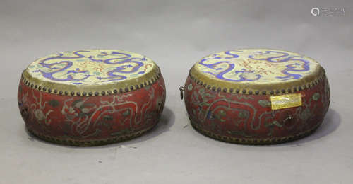 A pair of Chinese lacquered and painted wooden drums, Qing dynasty, of typical flattened circular