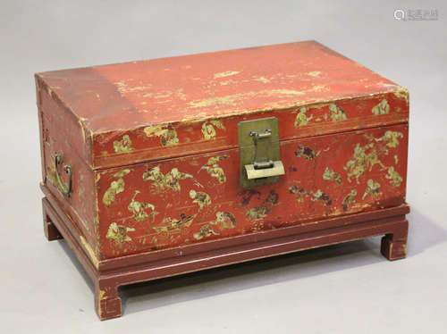 A Chinese red lacquered vellum trunk, late Qing dynasty, the front and sides gilt with figures and