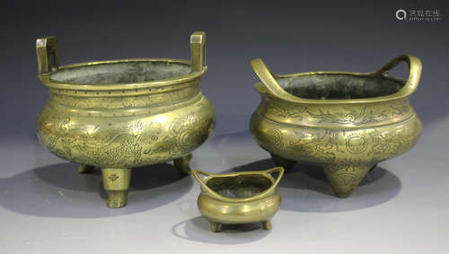 Two Chinese polished bronze tripod censers, mark of Xuande but early 20th century, each of