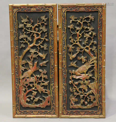 A pair of Chinese carved red lacquered and giltwood rectangular panels, early 20th century, each