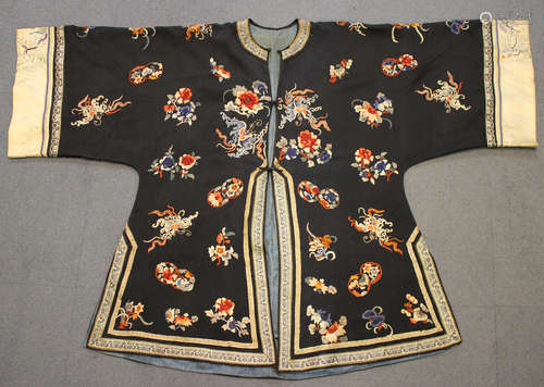 A Chinese midnight blue silk embroidered short jacket, late Qing dynasty, finely worked in