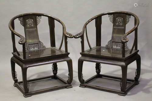 A pair of Chinese hardwood horseshoe back armchairs, 20th century, each splat back with pierced