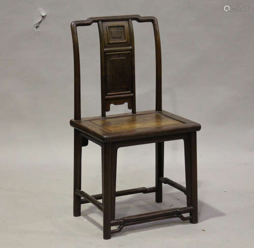 A Chinese hongmu chair, late Qing dynasty, the shaped top rail above a panelled splat back and