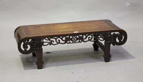 A Chinese hardwood low table, early 20th century, the rectangular panelled top with scroll ends