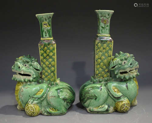 A pair of Chinese famille verte enamelled biscuit porcelain Buddhistic lion spill vases, Kangxi