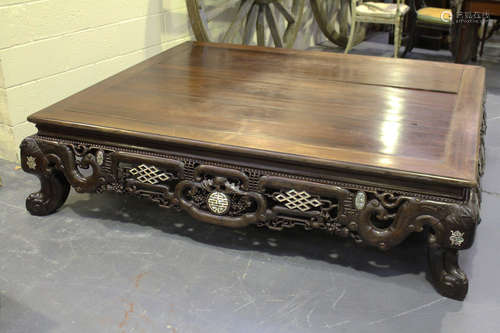 A Chinese mother-of-pearl inlaid hardwood opium bed, late Qing dynasty, the rectangular panelled top