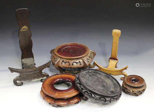 A collection of eighteen Chinese circular wood stands, late Qing dynasty and later, including some