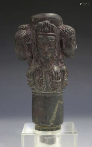 A Nepalese carved stone handle/pommel, possible 17th century, carved in relief with four heads of