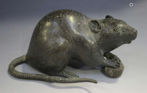 A Japanese brown patinated bronze figure of a rat, Meiji period, modelled clasping a nut,