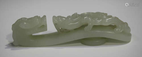 A Chinese pale celadon jade belt hook, late Qing dynasty or possibly later, of typical serpentine