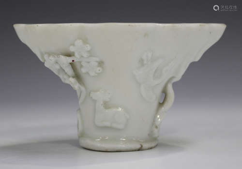 A Chinese blanc-de-Chine porcelain libation cup, probably Kangxi period, of traditional horn form,