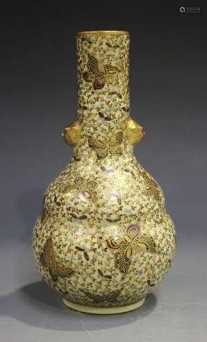 A Japanese Satsuma earthenware bottle vase, Meiji period, painted and gilt with butterflies