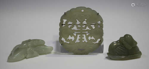 A Chinese silver mounted pale celadon jade plaque brooch, early 20th century, carved and pierced