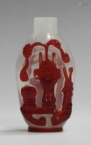 A Chinese Peking red overlay glass snuff bottle, late Qing dynasty, each side well carved with