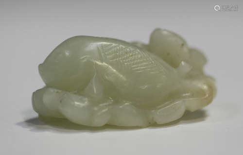 A Chinese pale celadon jade pendant, late Qing dynasty, carved in the form of a fish, pine branch