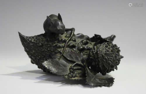 A Japanese brown patinated bronze figure group, Meiji period, finely modelled as a rat seated upon a