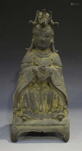 A Chinese cast bronze figure of Guanyin, probably Ming dynasty, with traces of gilt, modelled seated