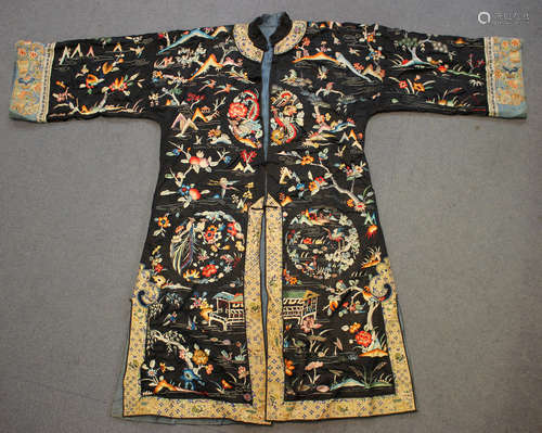 A Chinese black silk embroidered robe, early 20th century, worked in coloured threads with an