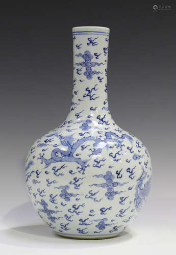 A Chinese blue and white porcelain bottle vase, painted with dragons and phoenixes amidst clouds and