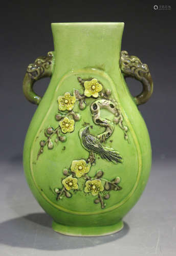 A Chinese famille verte enamelled biscuit porcelain vase of hu form, each side moulded in relief